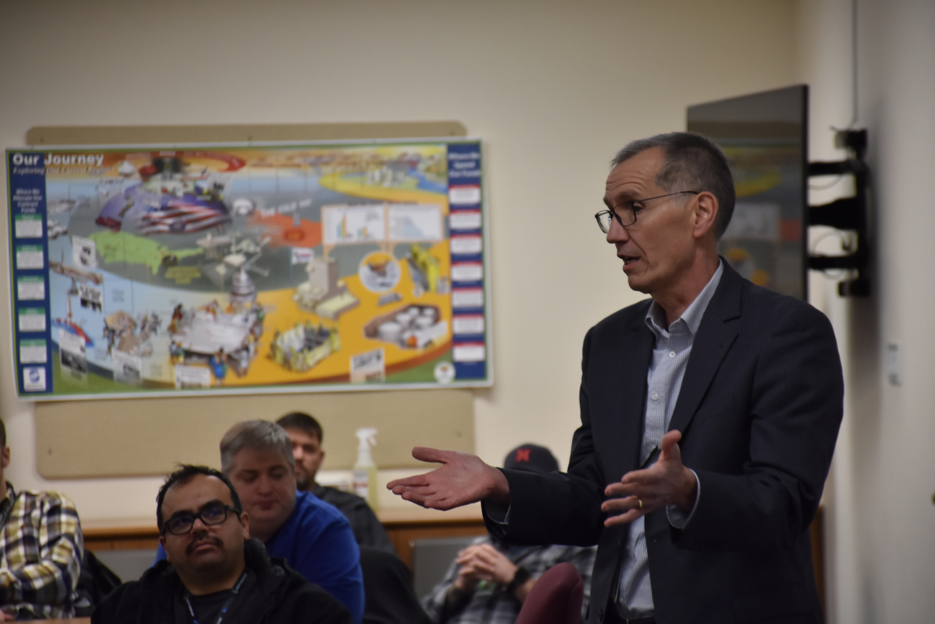 A man speaks to a room of people