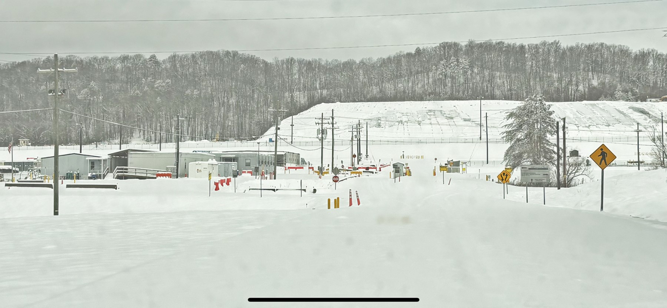 A snow covered road and facility building