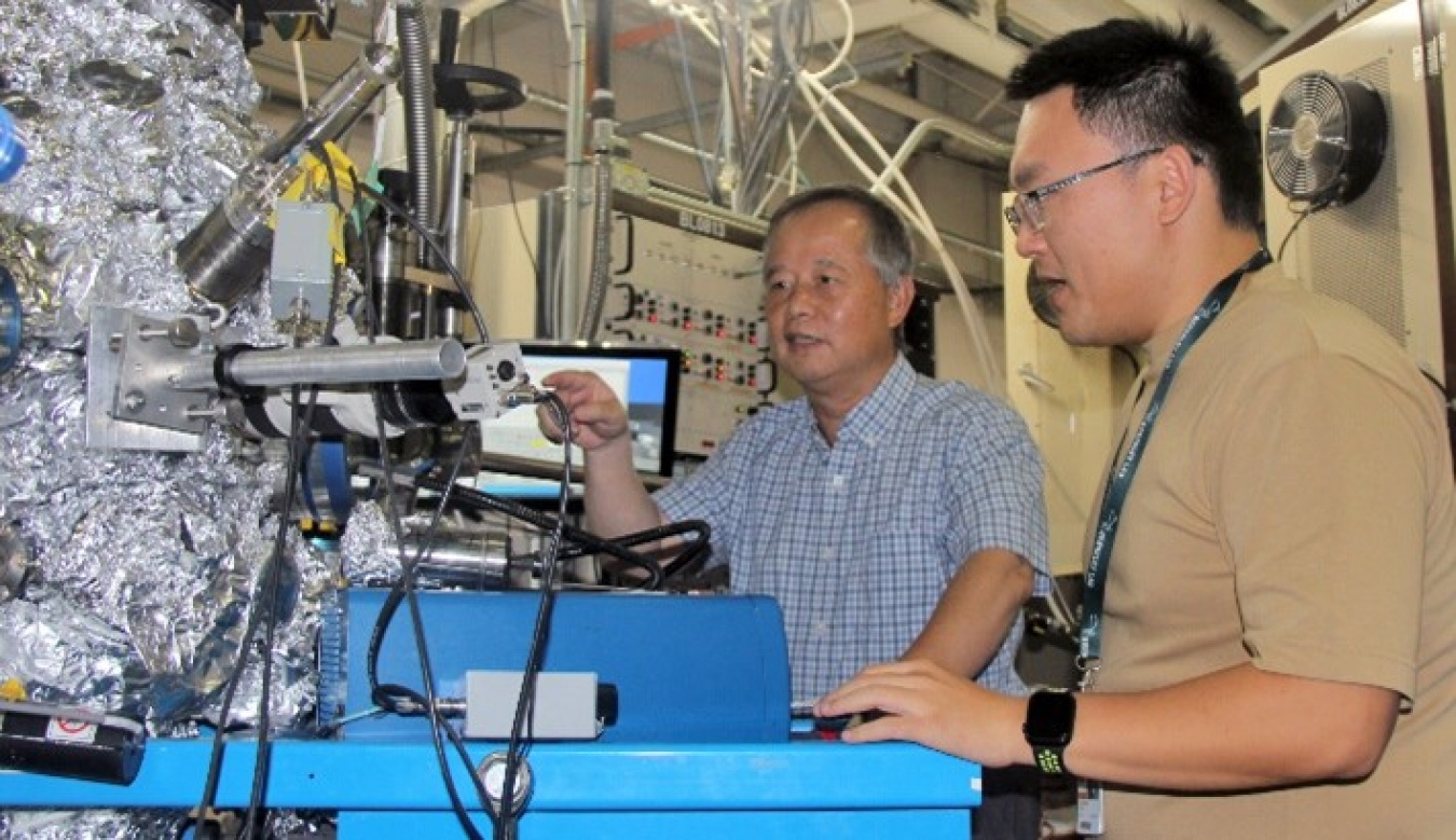 Two scientists operate lab equipment at Berkeley Lab's Advanced Light Source