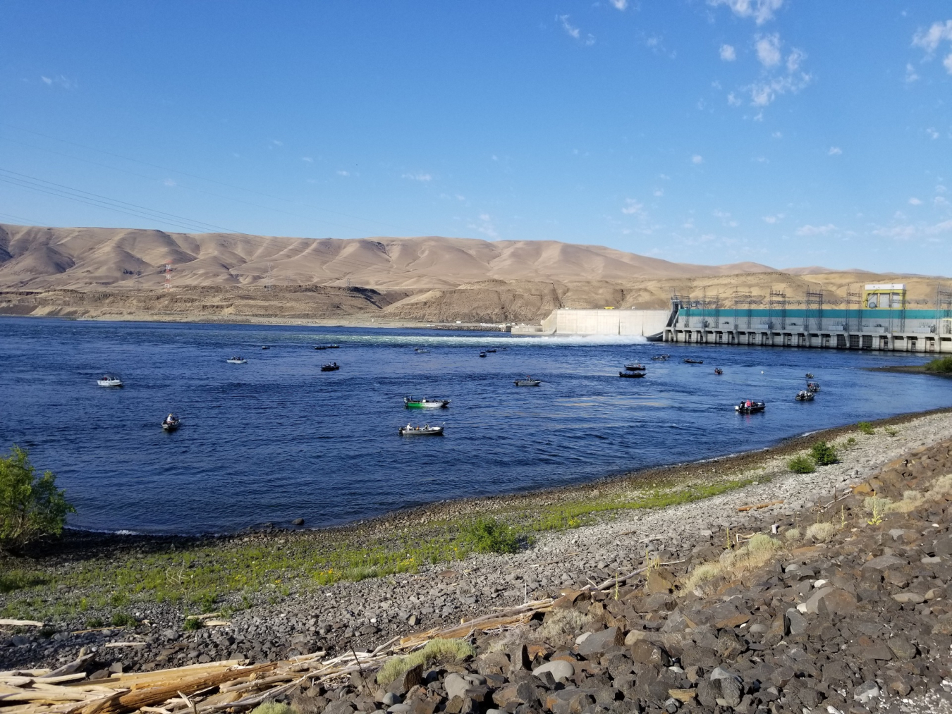 Fishing boats in front of a dam