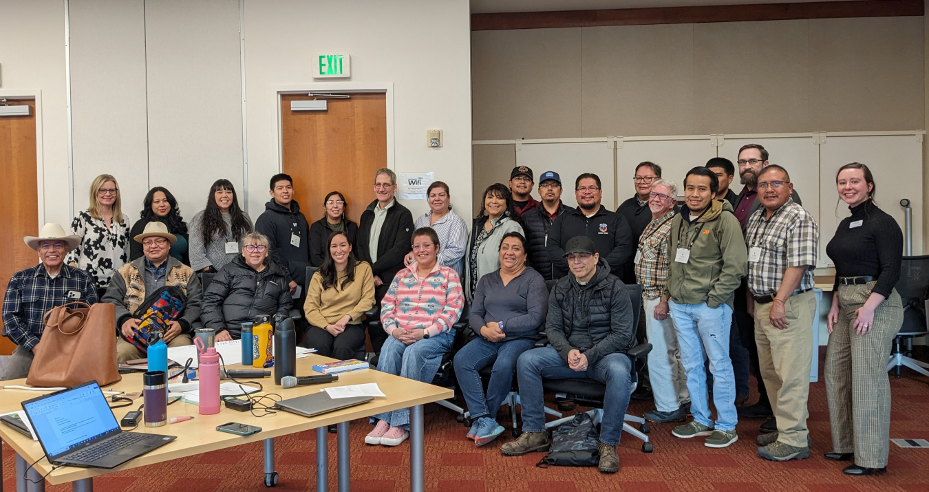 A large group of people posing for a picture in a conference room