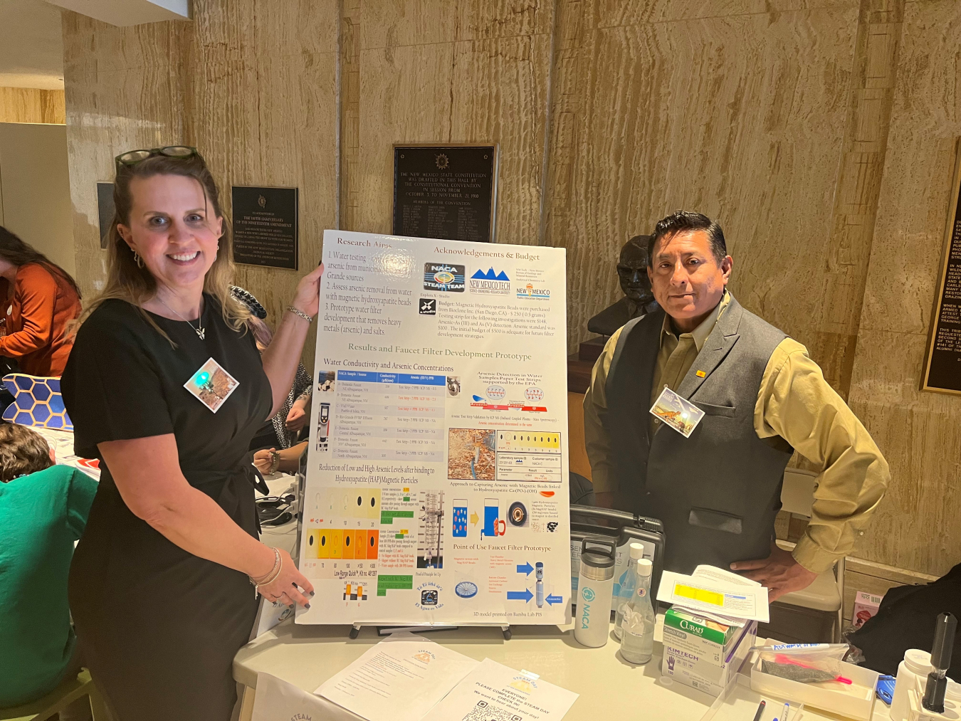 Two employees with an informative poster