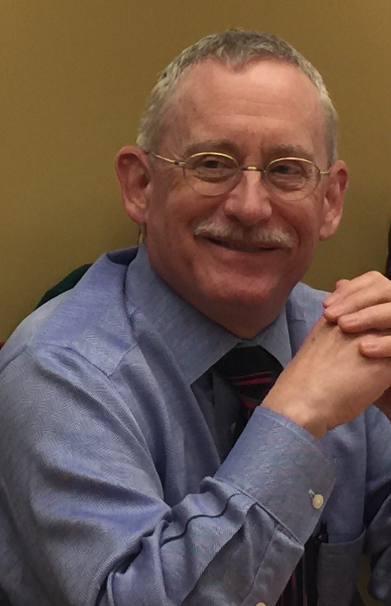 A headshot of Neal Elliott