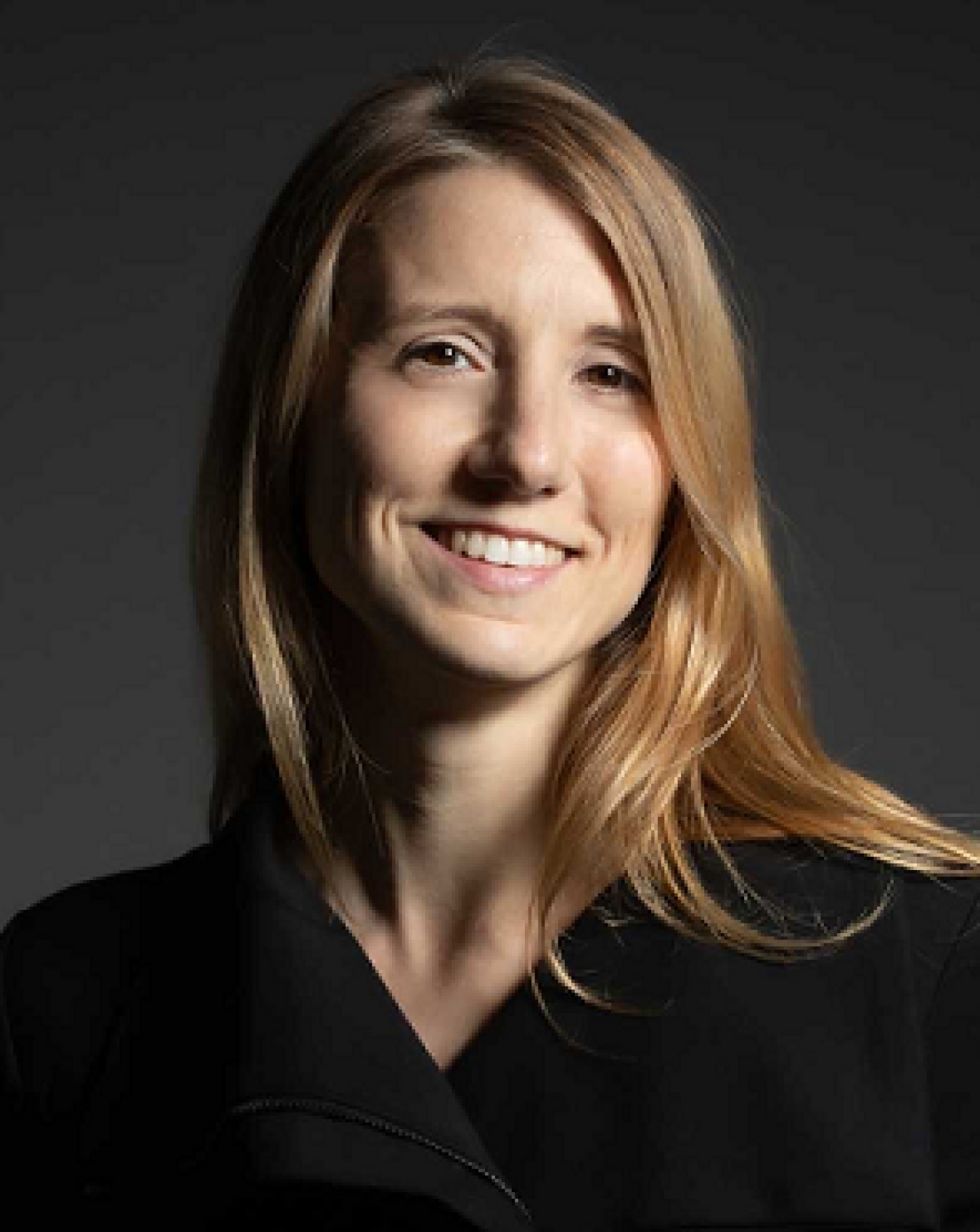 A woman smiles at the camera.