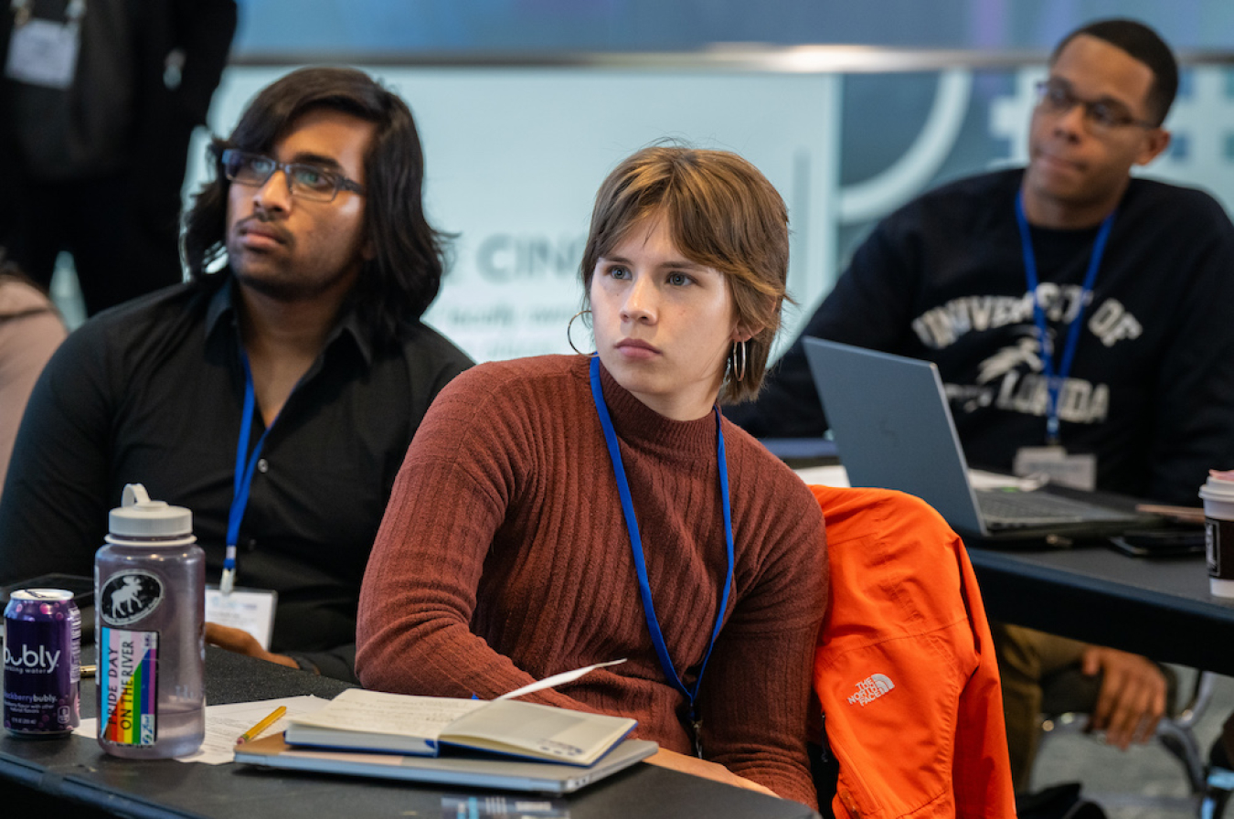 Three students look on in a classroom during a session at CleanCurrents