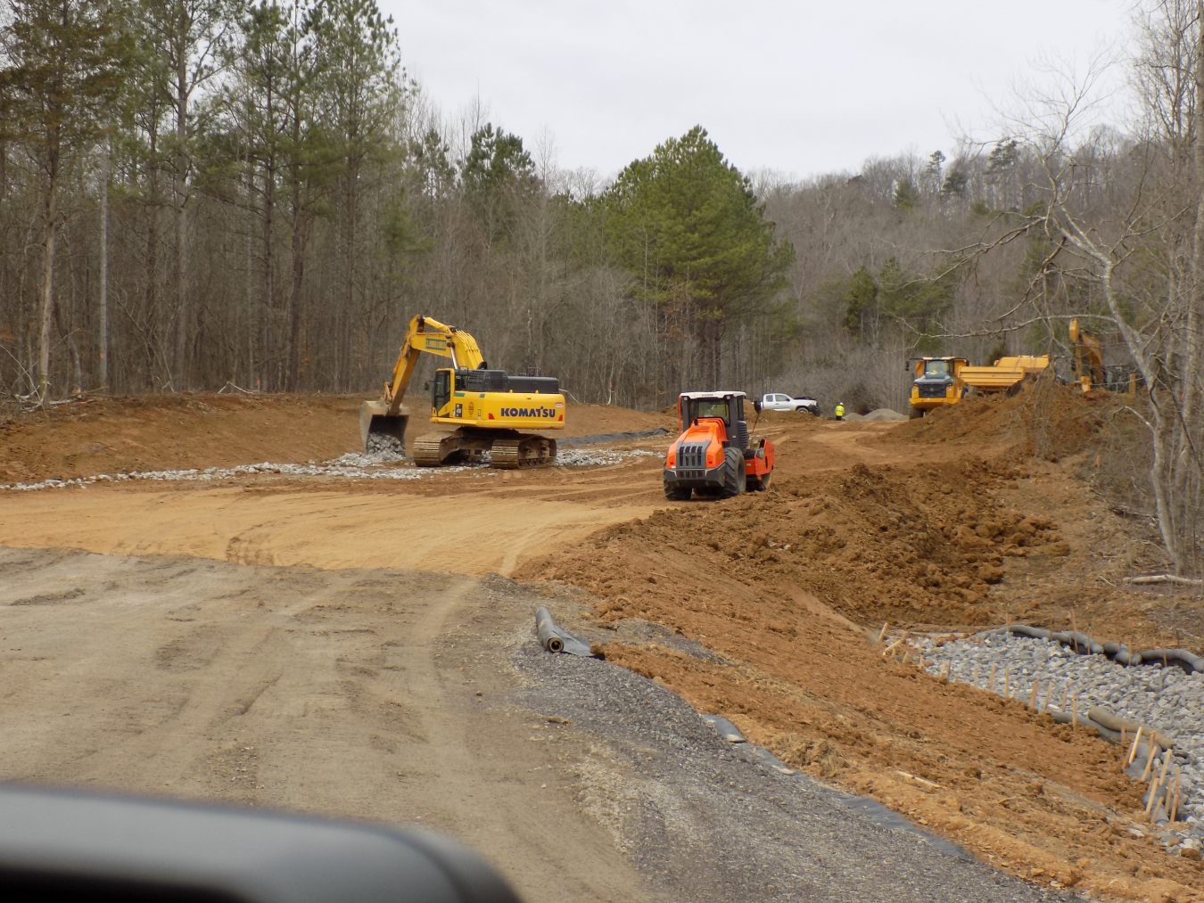 Dirt open work field area with working machines