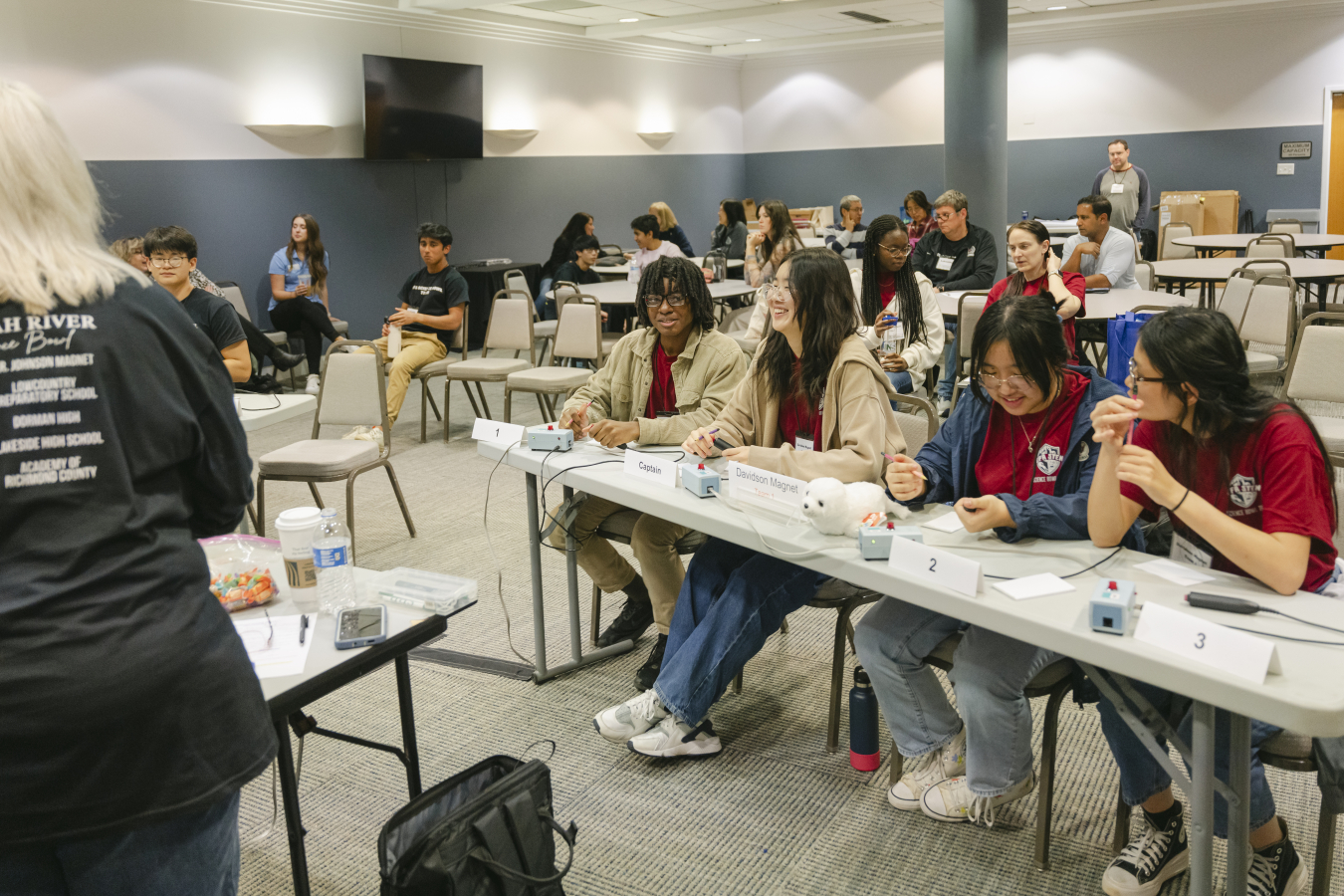 High school students sitting at a table practicing for a science bowl
