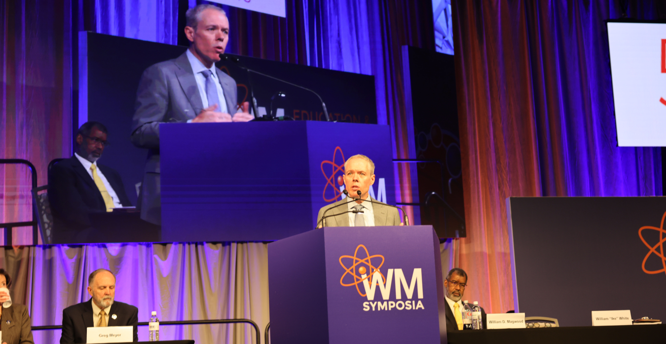 Ike White speaking at a podium on stage