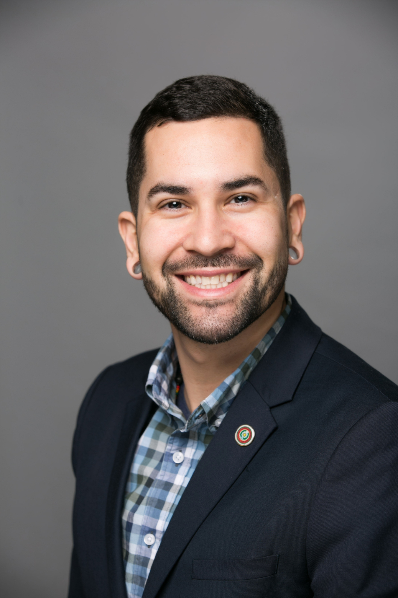 Headshot of Joseph Owle with a big, enthusiatic smile.