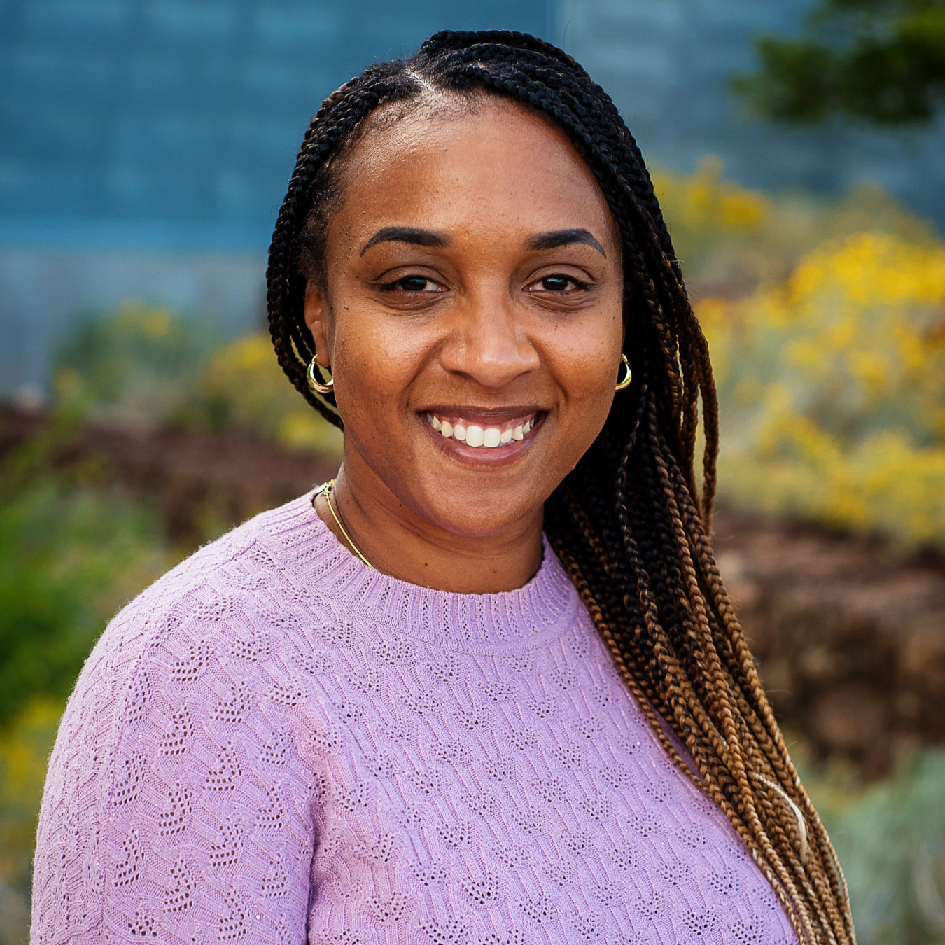 A woman poses and smiles for the camera.