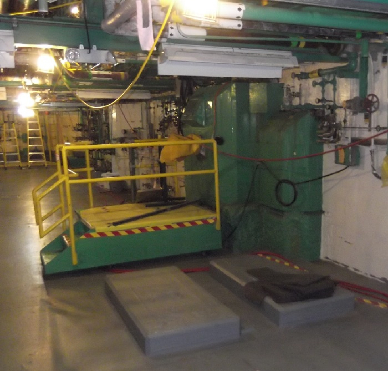 A "green giant" system attached to the wall of the inside of a work facility building