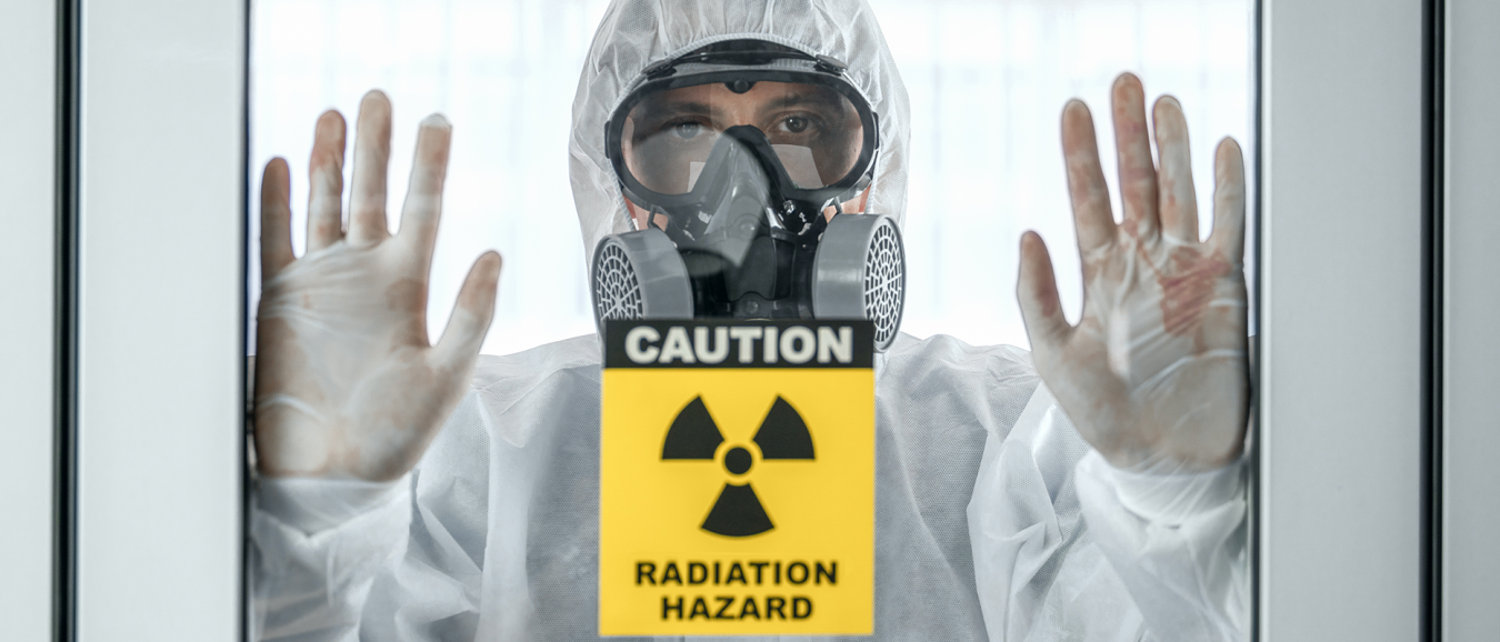 main in protective gear,with yellow and black radiation hazard symbol and text