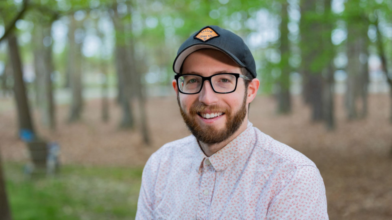 Headshot of Christian Cagnino with forest in background 
