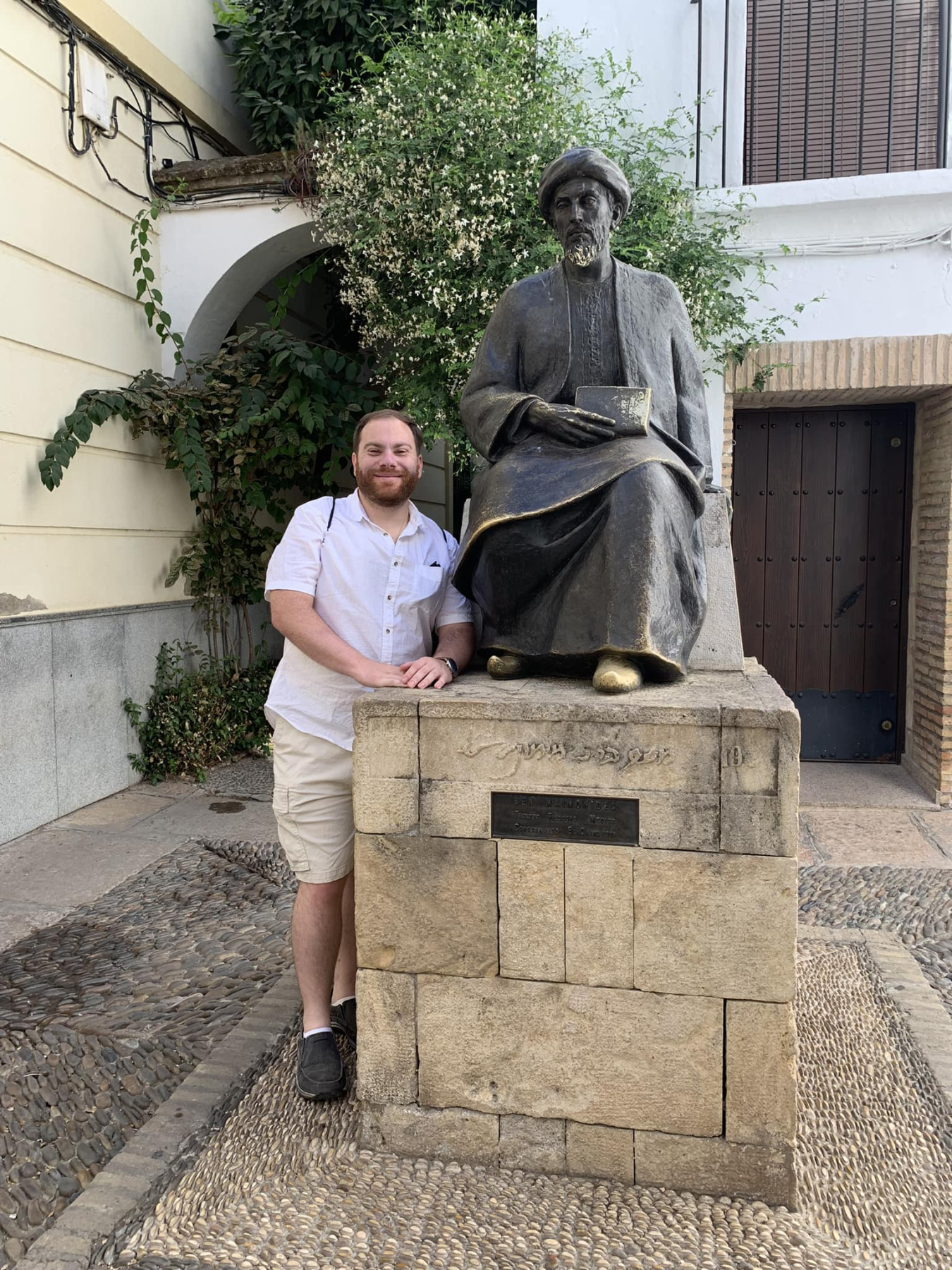 Daniel next to a statue of Moses Maimonides in Cordoba, Spain.