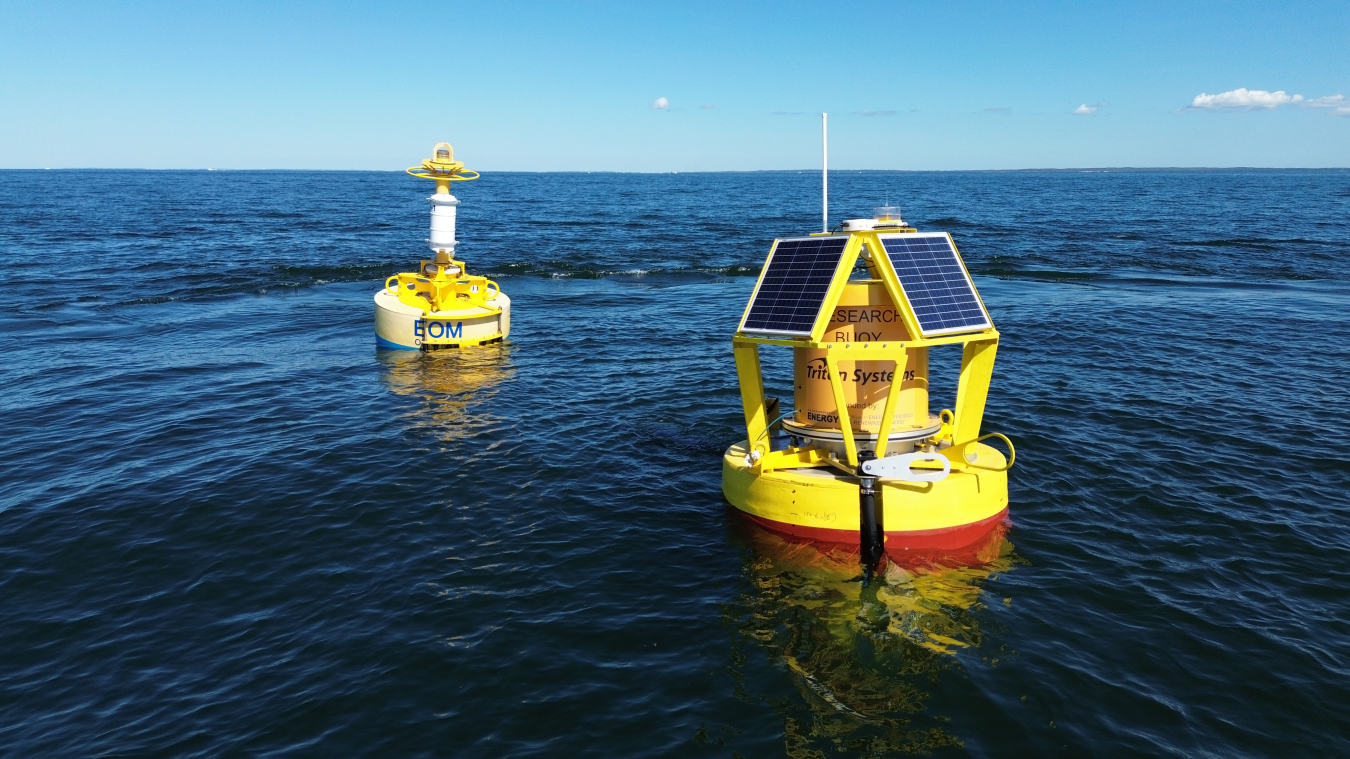 Two buoys floating side by side in water