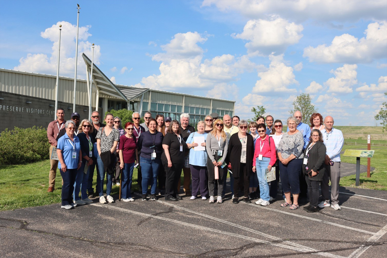A large group of people pose for a picture outside a building