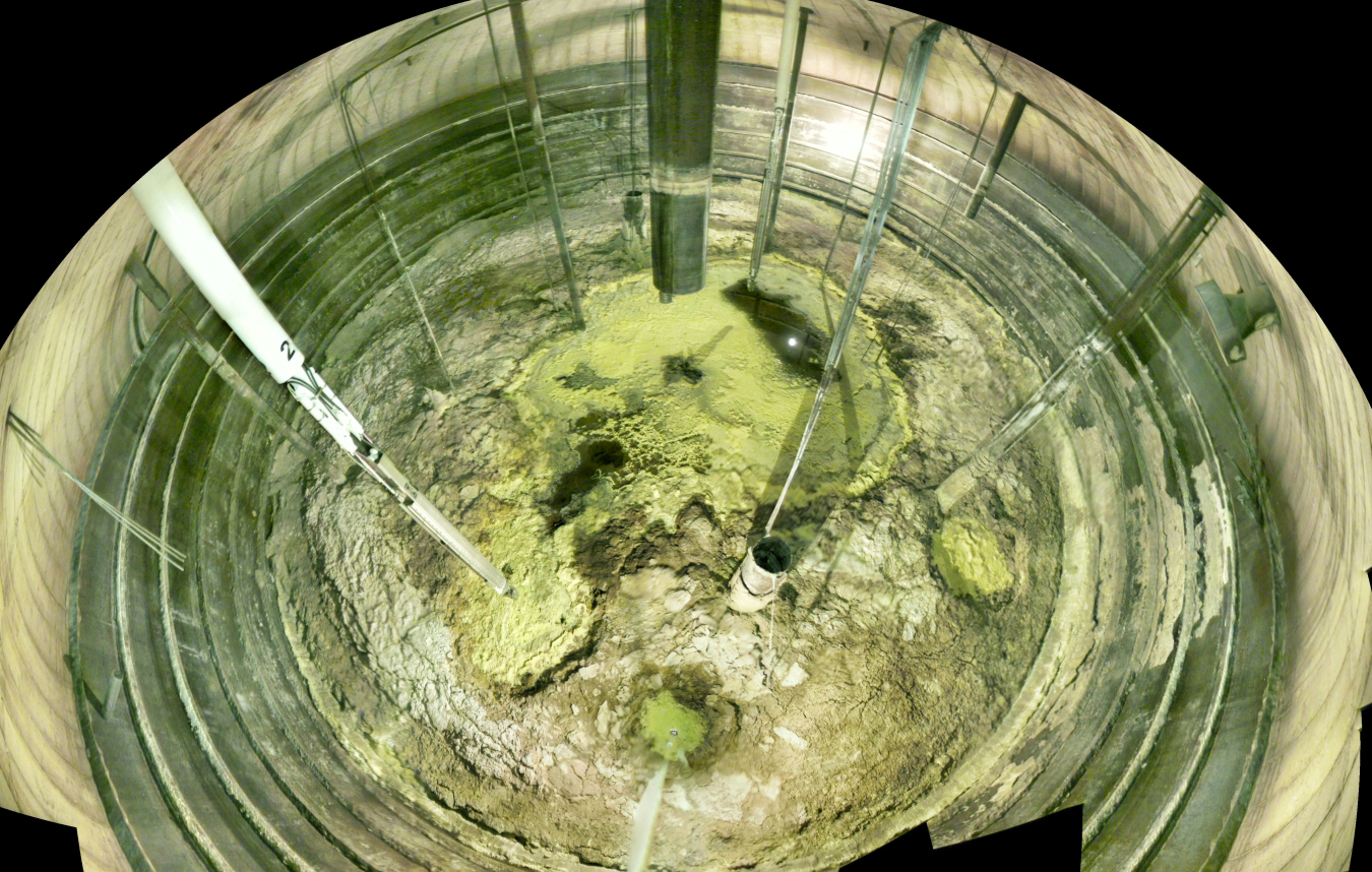 The inside of a tank that stores waste. The bottom is crumbly and dry looking