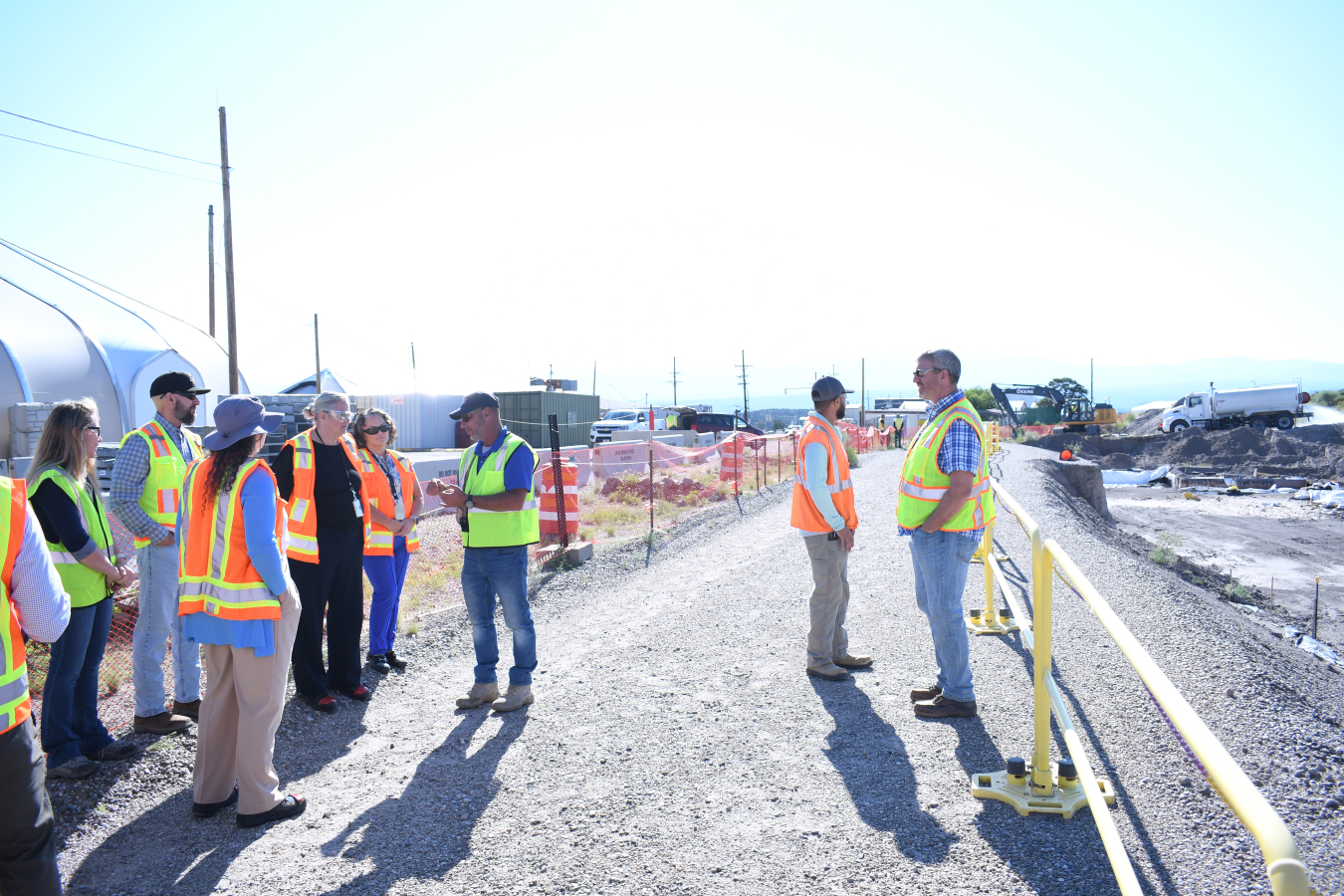 A group of EM leaders stand outside at a Los Alamos work site
