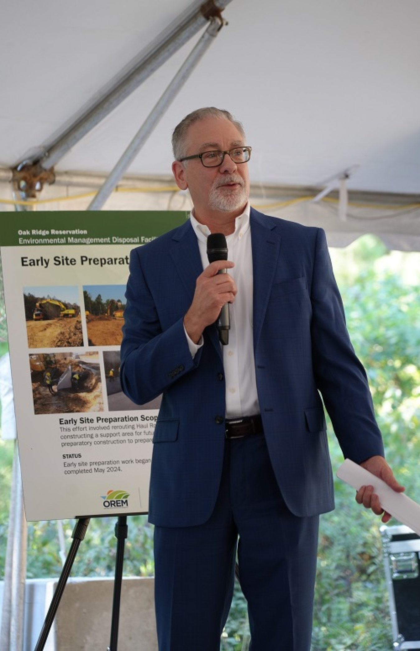 A man speaks to tour participants.