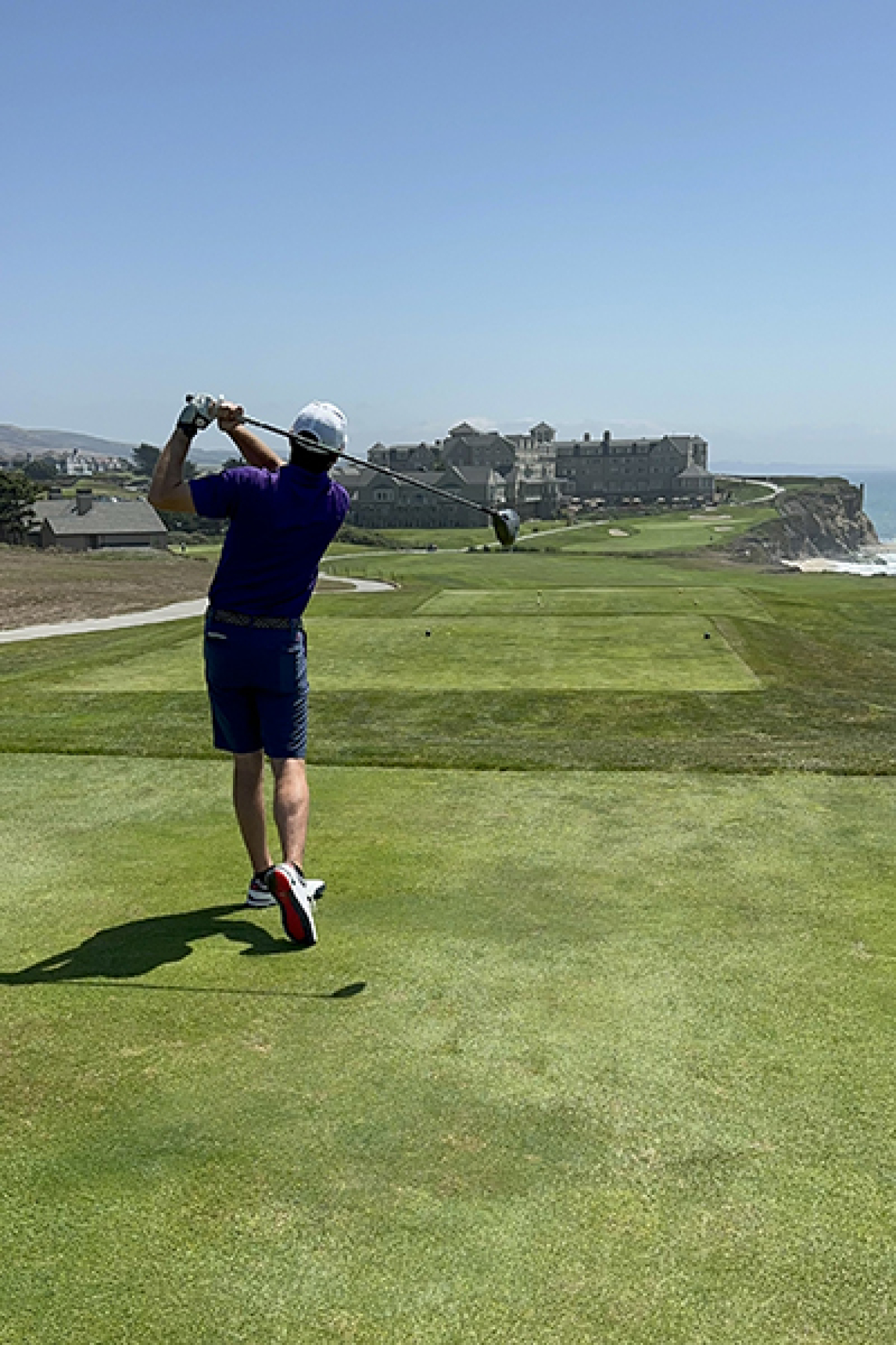 A person who just swung a club on a golf course.