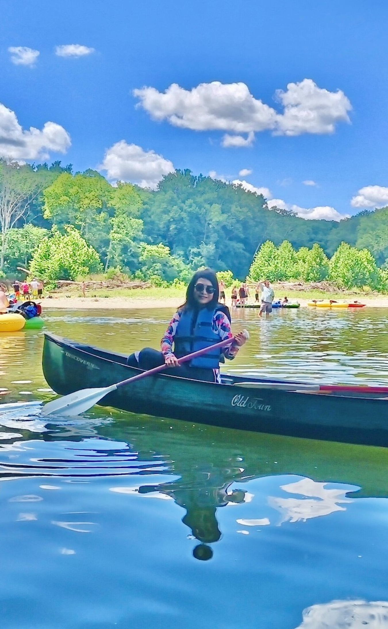 A person canoeing on a lake in the mountains