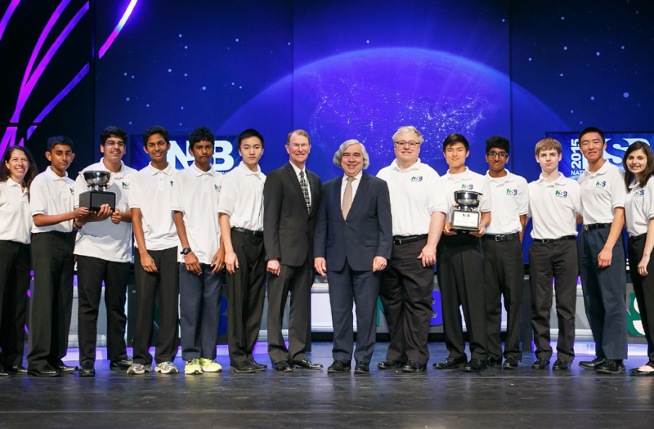 Secretary of Energy Dr. Ernest J. Moniz and Under Secretary for Science and Energy Dr. Franklin Orr, pose for a photo with (from left) the 2015 National Science Bowl high school and middle school champions.
