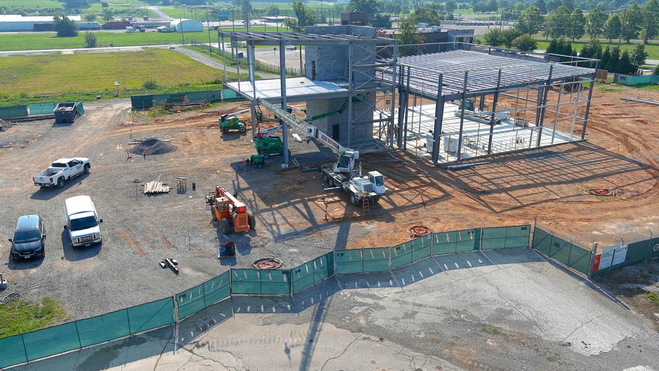 Overhead view of a building in the process of being built, lots of steel beams stand where the building is