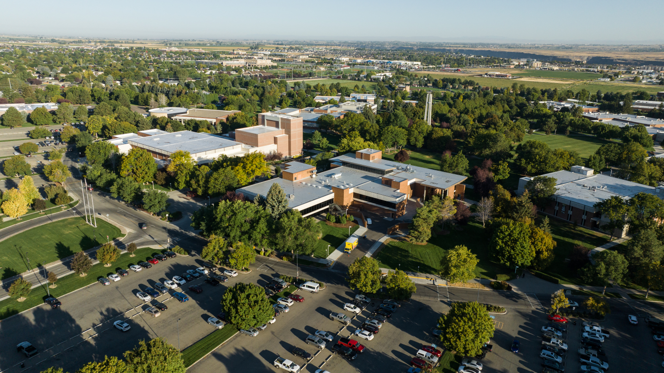 Aerial photograph of a college campus with 5 buildings and a bell tower visible.