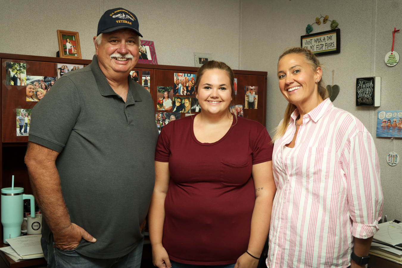 Parents pose with their daughter in an office building