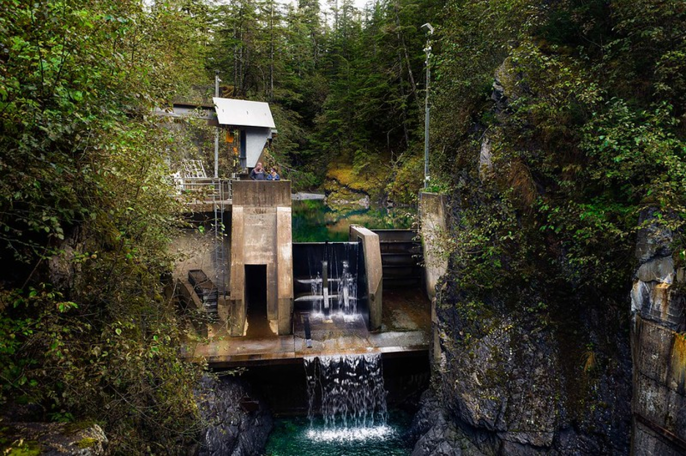 a photo containing a small hydropower plant with cascading water.