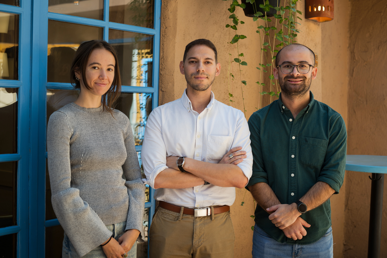 Three people pose and smile for the camera.