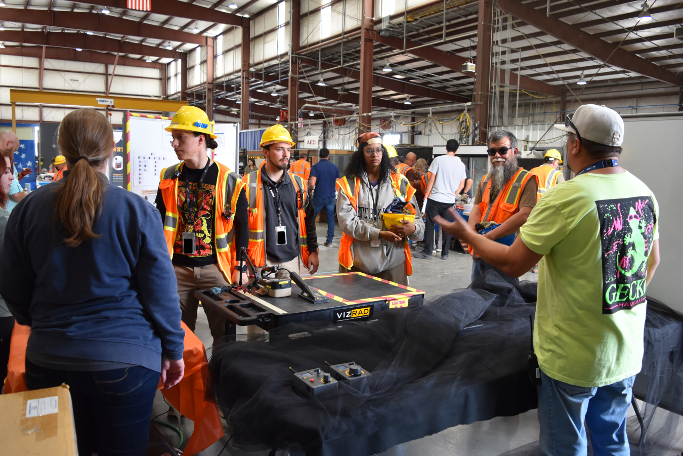  A group of employees in safety gear participate in a discussion