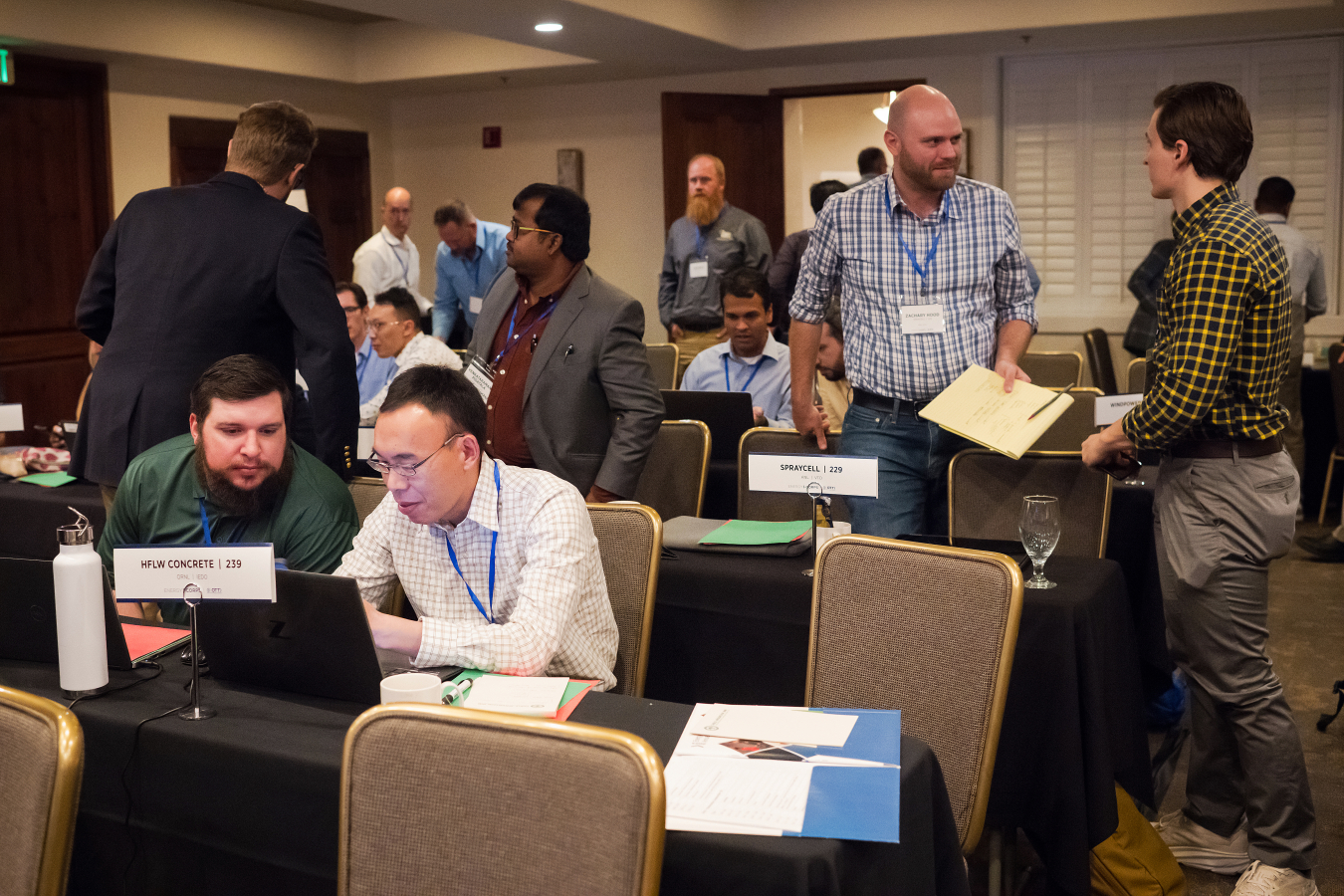 A group of people in a room, working and talking