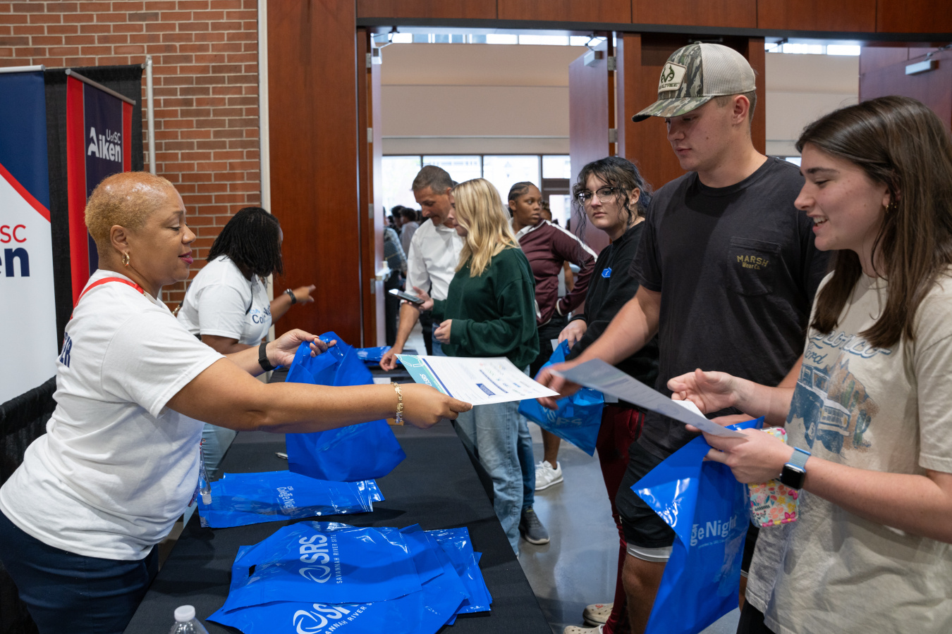 College students and their parents check in for a college career fair