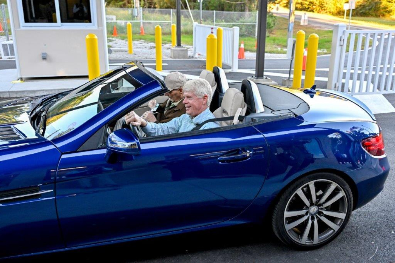 Two people in a car drive through a new barricade at the Savannah River Site.