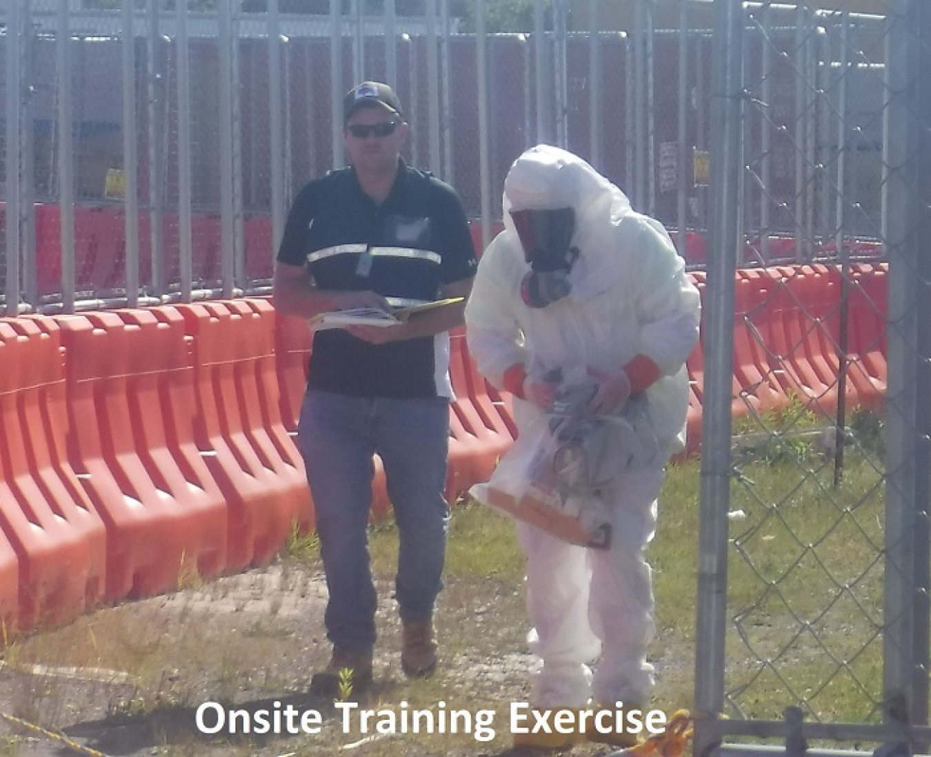 A radiation control technician surveys an area during an exercise.