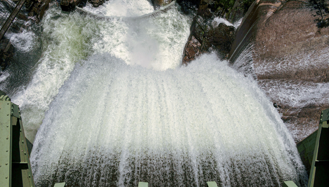 Water flows through a dam, showing how rivers power cities via hydroelectricity