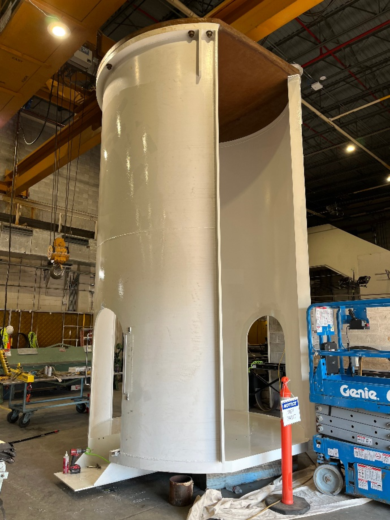 A large, white, cylinder inside a facility building