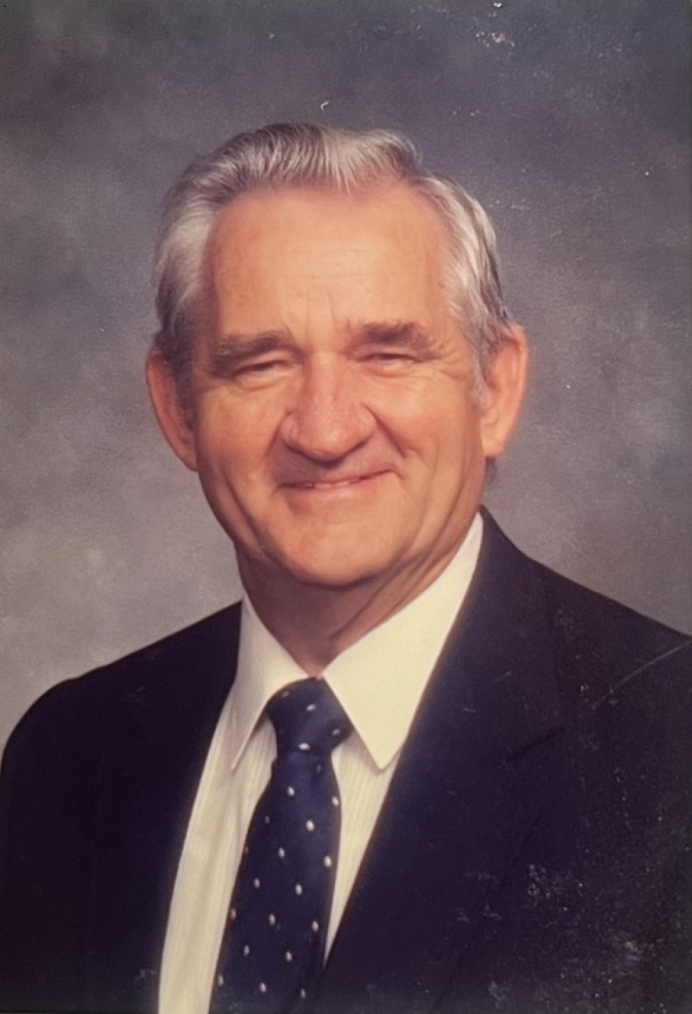 An older portrait of a man in a suit