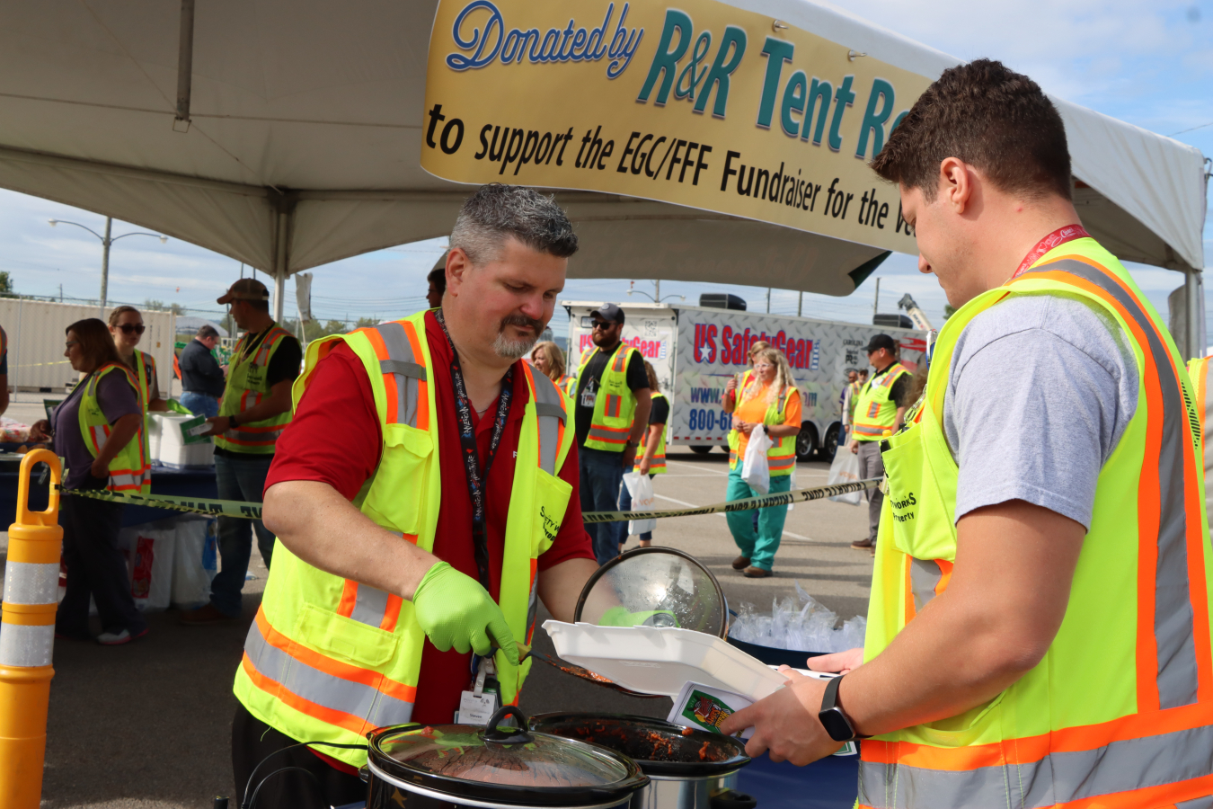 A person serves food to another person.