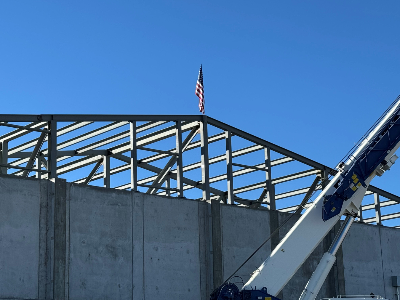 The frame of a building with an American flag on top