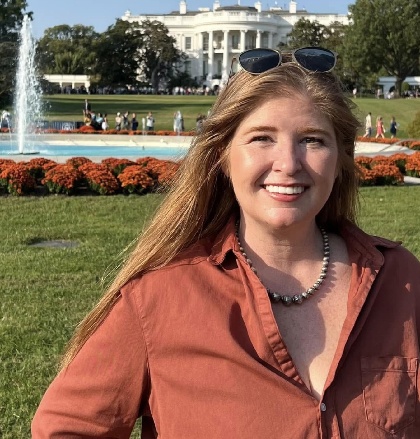 Sarah Harman headshot in front of the White House
