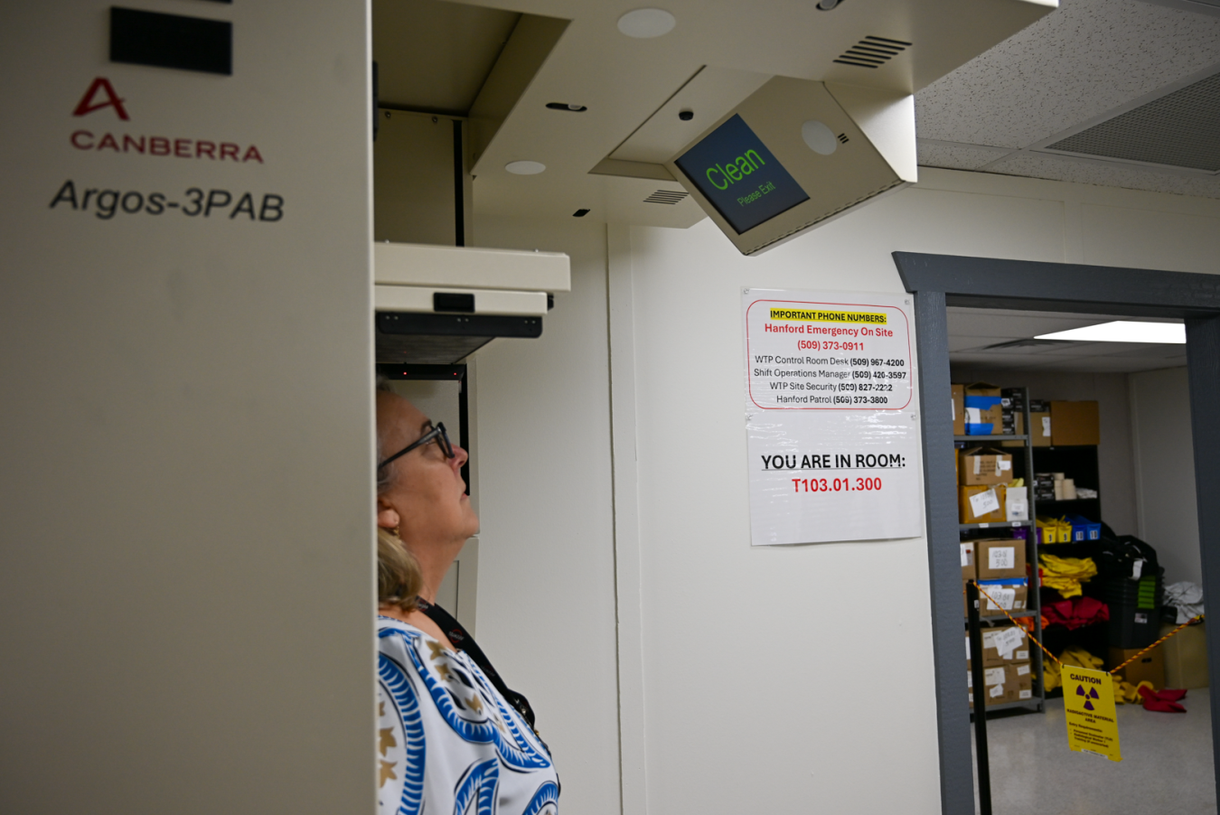 A woman inside a machine looks up at a screen that says "Clear" in green