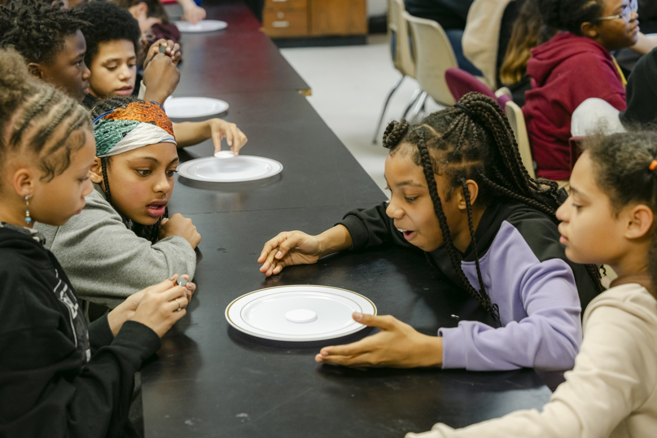 A group of middle school students participating in engineering science experiments