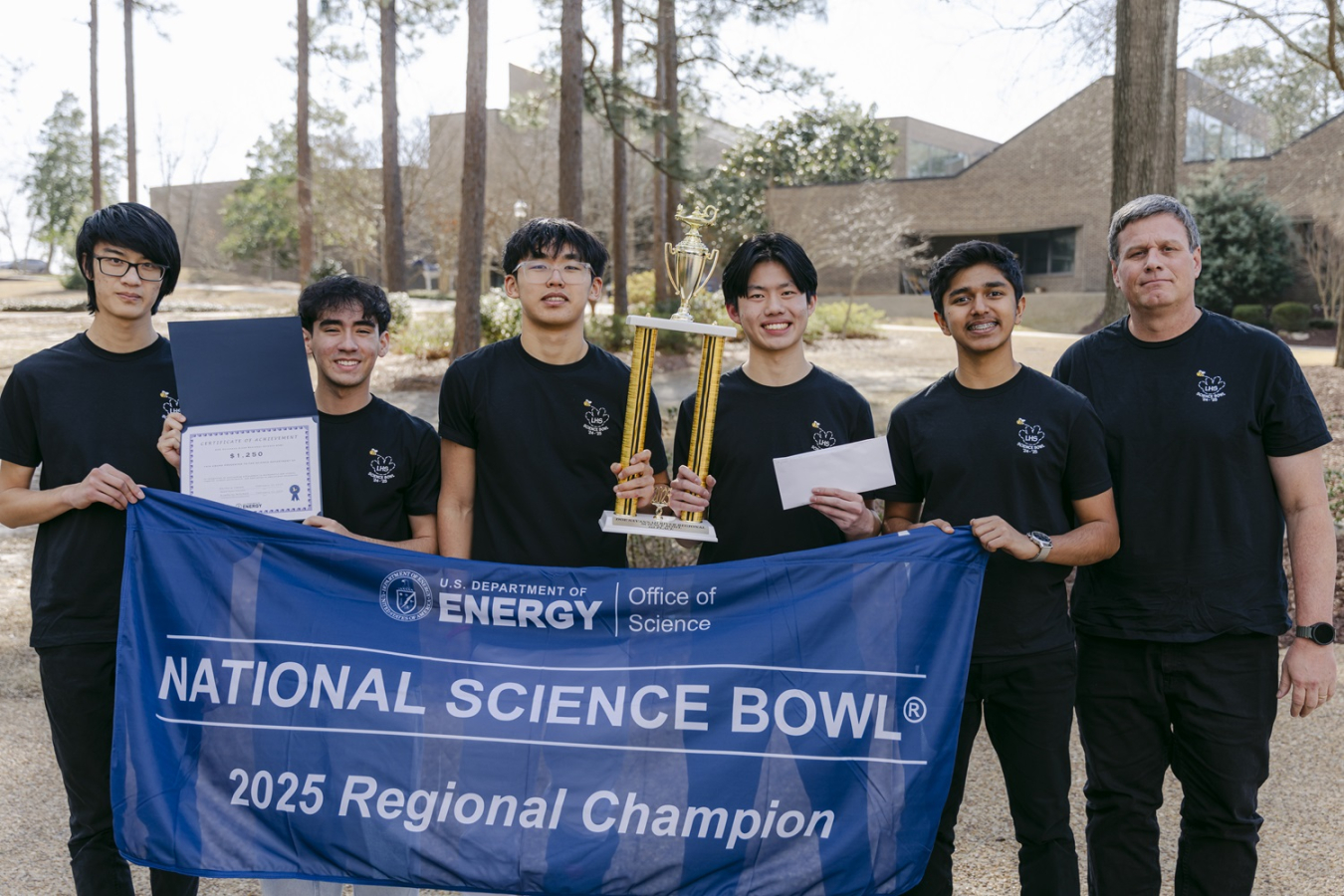 A group of students pose for a picture after winning a science bowl competition