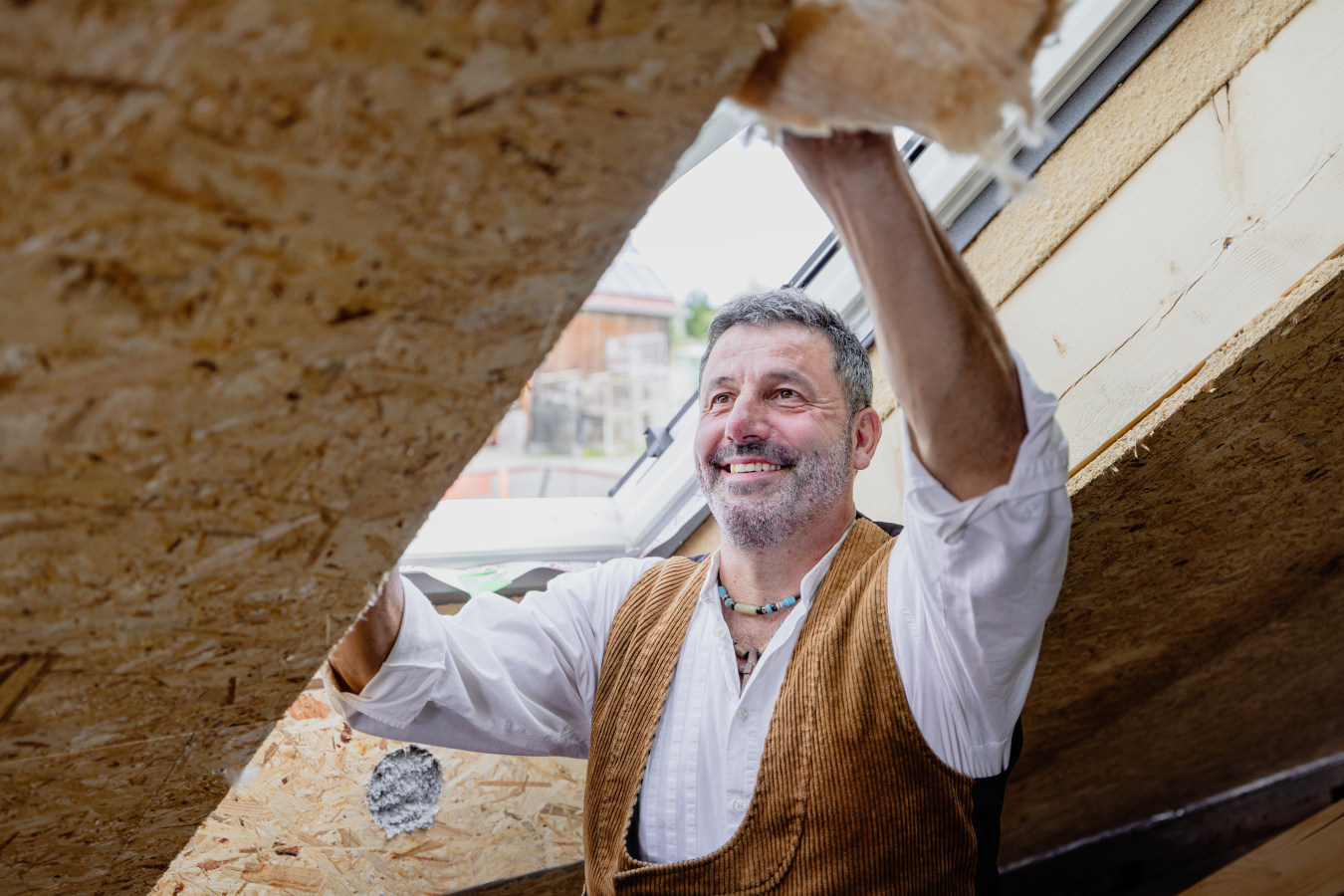 Person installing insulation. 