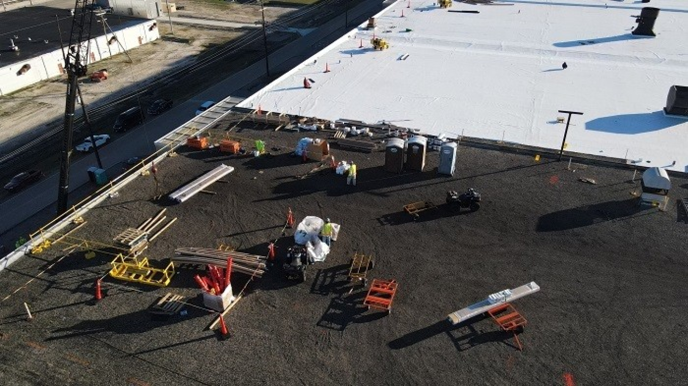 Workers use two layers of thick materials to cover the existing roof of the X-330 Process Building at the Portsmouth Site.