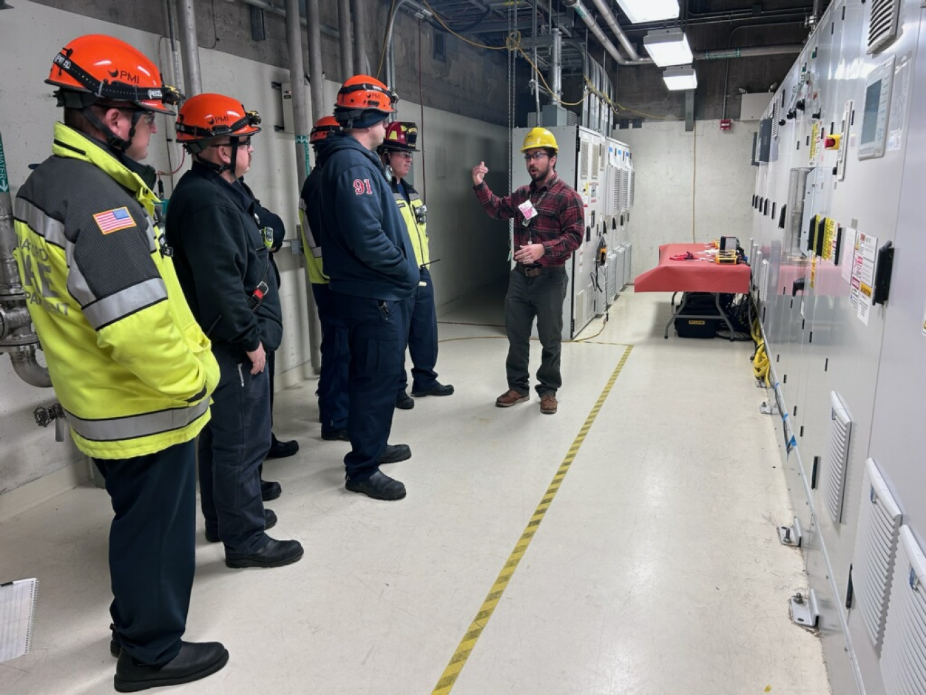 A group of employees stand in an emergency response room 