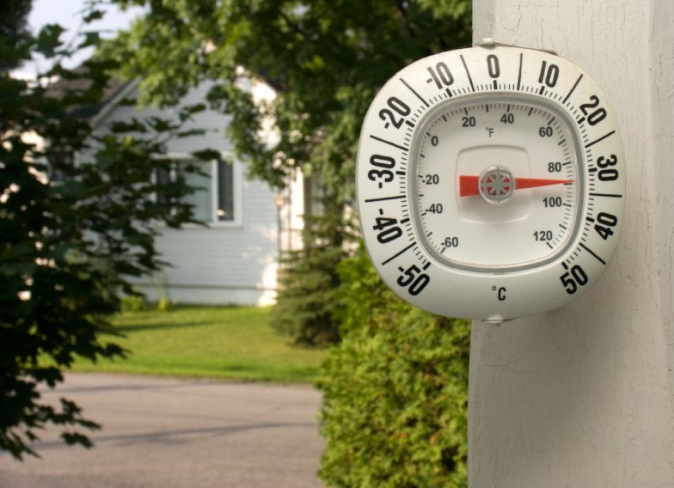 An outdoor thermometer showing hot temperatures.