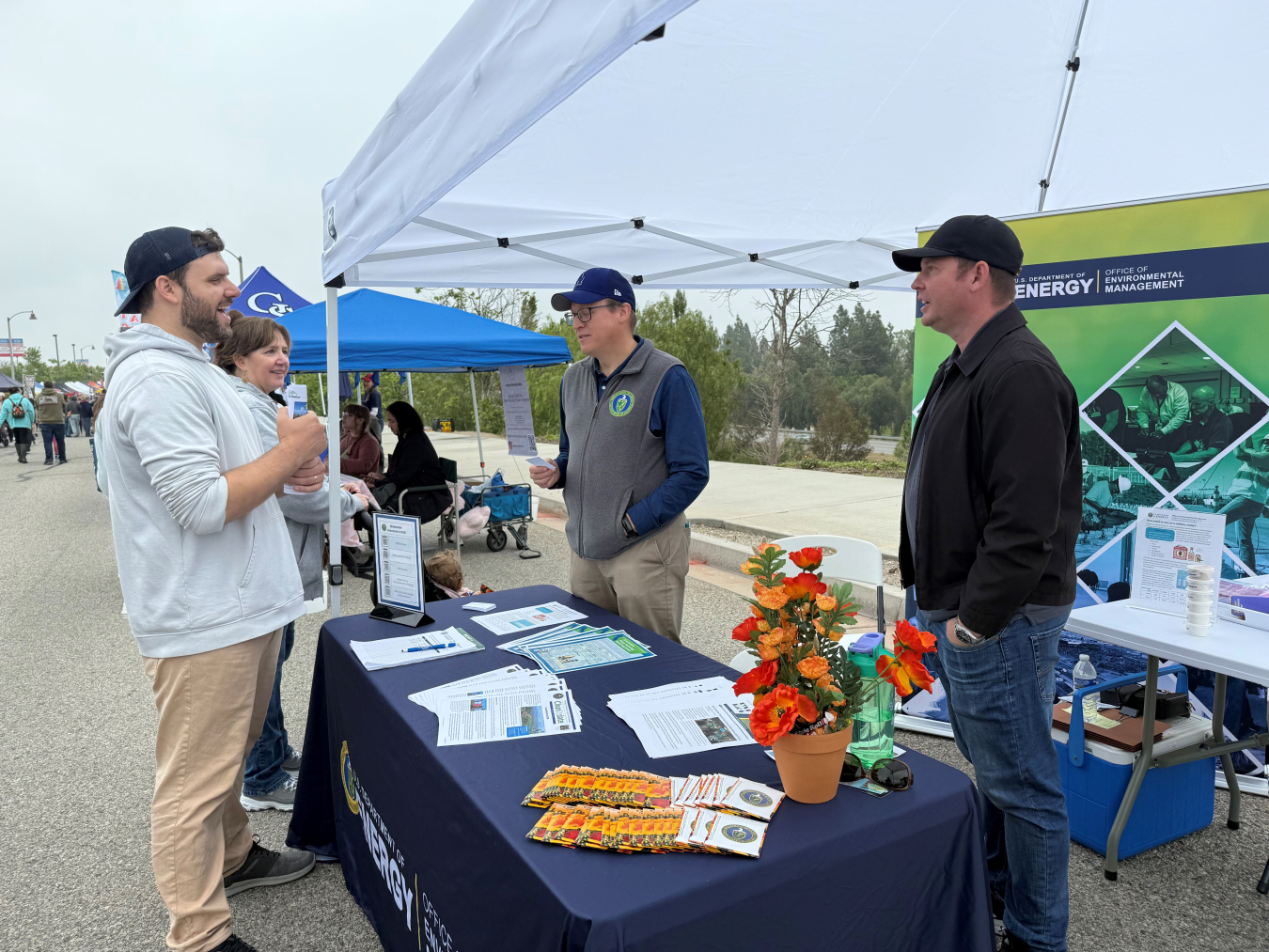 Employees and citizens at a street fair booth